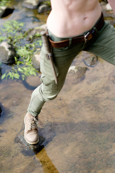 Close up legs of skinny white woman, crossing the river. Survive and travel concept.  - Photo, Image