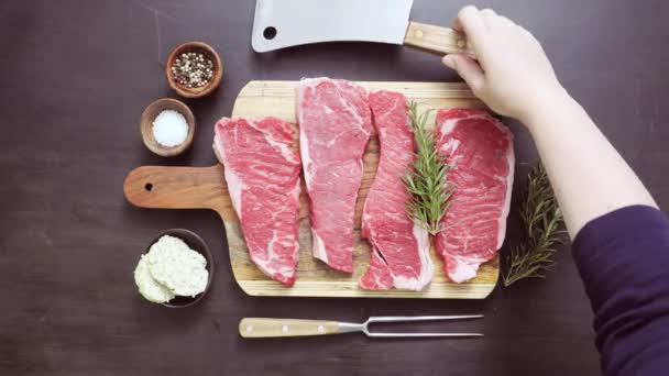 Raw New York strip steaks on a wood cutting board. - Footage, Video