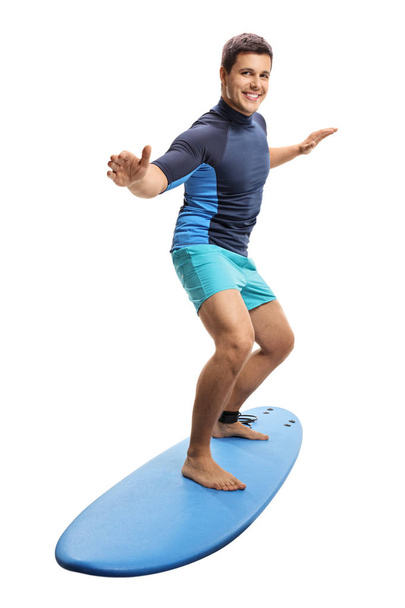 Full length portrait of a surfer surfing on a surfboard isolated on white background - Foto, Bild