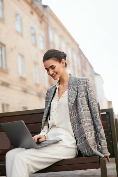 Business Woman Working On Computer At Street. Girl Using Laptop Outdoors. High Resolution - Фото, изображение