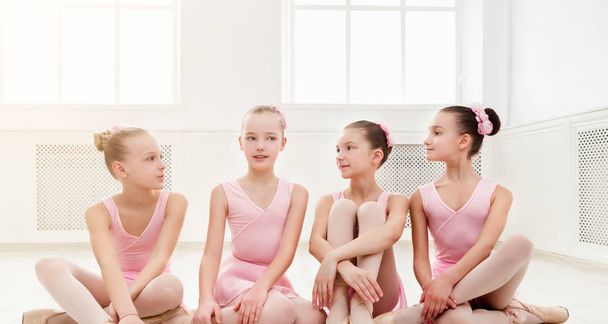 Little ballerinas talking in ballet studio - Photo, Image