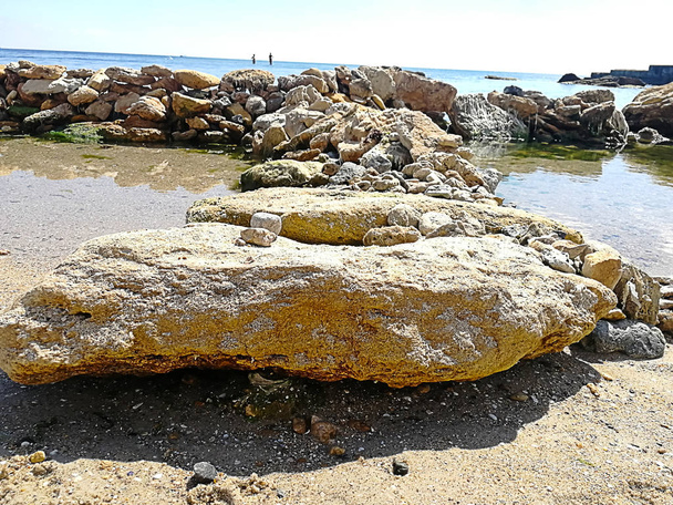 background of large stones that divide in two sides in the black sea in Odessa, Ukraine - Photo, Image