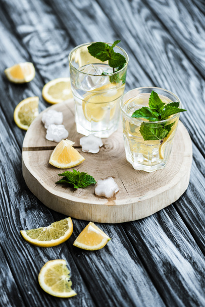 cold fresh summer cocktail with mint and ice cubes in glasses on wooden table - Photo, Image