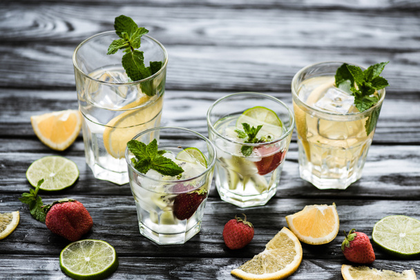 close-up view of glasses with fresh cold summer cocktails on wooden table - Фото, зображення