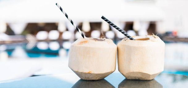 two green coconut cocktails with straws - Photo, Image