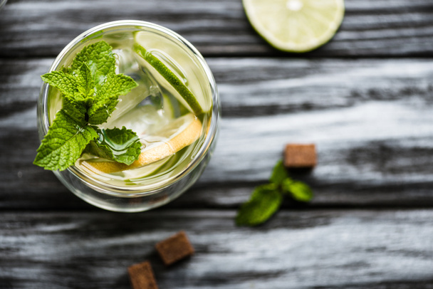 top view of fresh cold mojito cocktail in glass on wooden table  - Fotoğraf, Görsel