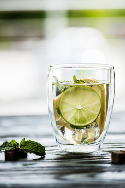 glass of cold fresh mojito with lime, mint and sugar   - Photo, Image