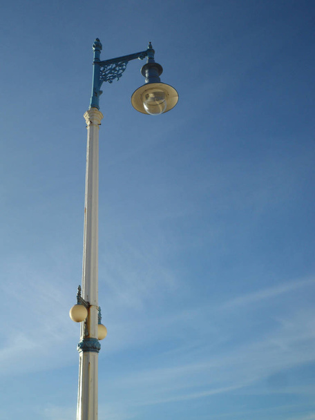 Old fashioned lamp light on the waterfront of Weymouth beach promenade in Dorset, England - Photo, Image