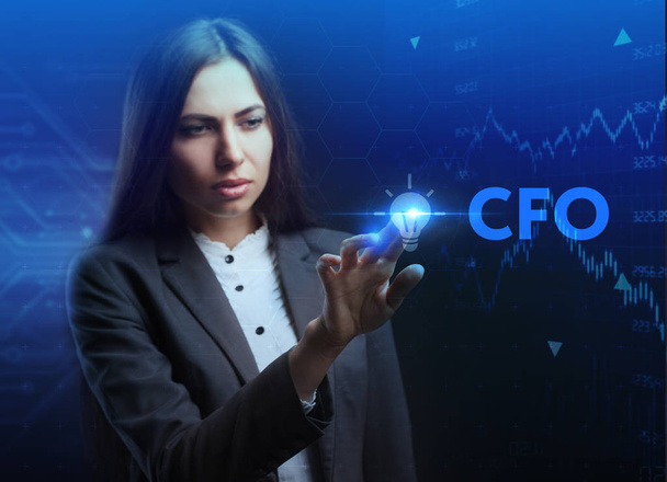 The concept of business, technology, the Internet and the network. A young entrepreneur working on a virtual screen of the future and sees the inscription: CFO - Zdjęcie, obraz
