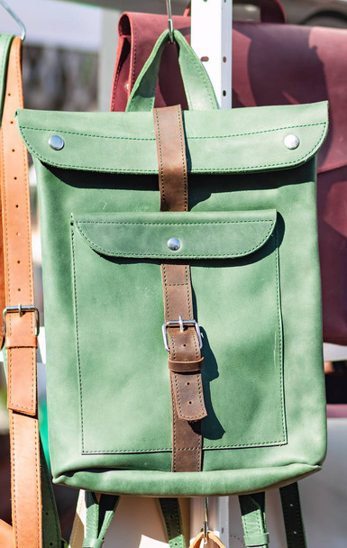 Green-coloured natural leather backpack in the bright midday sun - Photo, Image