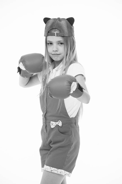 Child in boxing gloves isolated on white. Little girl before training or workout. Kid athlete in fashionable cap. Fashion, style and trend. Sport activity and energy - Photo, image