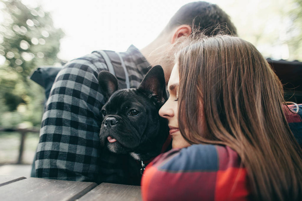Loving couple with pet french bulldog - Photo, image