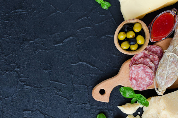 Mediterranean appetizers, tapas or antipasti. Assorted Italian traditional products food set. Delicious snack on party. Chopping board with meat and cheese. Top view. Copy space. - Photo, Image