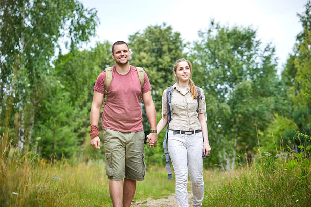 two travelers walking in forest at sunny day  - Foto, Imagem