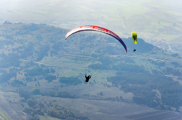 paragliders flying over valley in summer sunny day - Zdjęcie, obraz