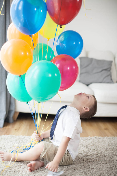 Портрет красивого мальчика 4 года с шариками. День рождения. Счастливый ребенок в костюме. Любовь
. - Фото, изображение