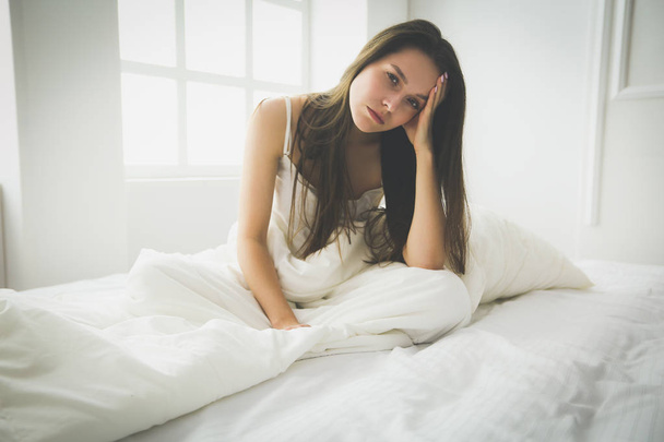 Young female feeling pain in bed. - Fotó, kép