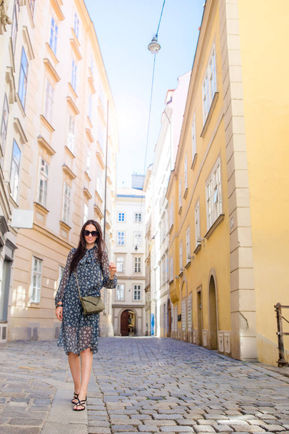 Uma mulher a andar na cidade. Jovem turista atraente ao ar livre na cidade italiana
 - Foto, Imagem