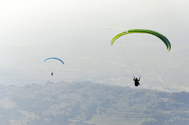 paragliders flying over valley in summer sunny day - 写真・画像