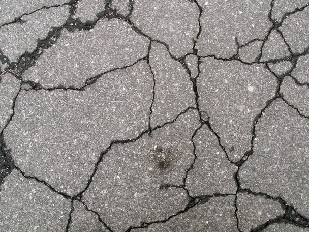 Cracked asphalt texture, may be used as background - Photo, Image