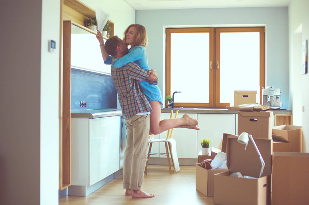 Portrait of young couple moving in new home. Young couple - Фото, зображення