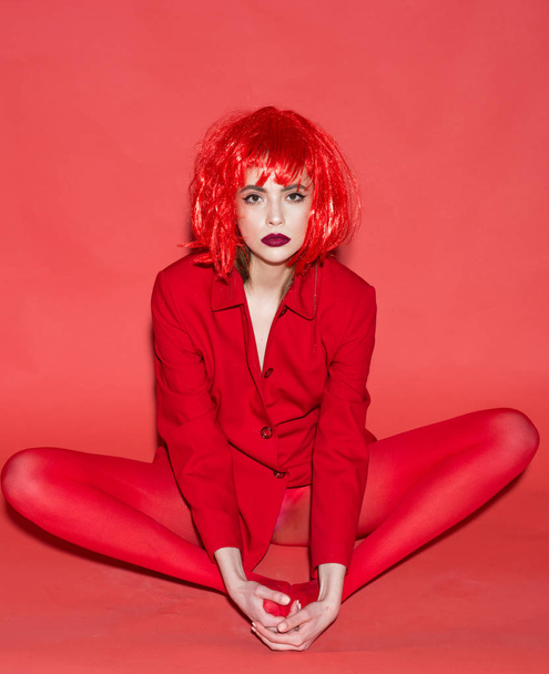 Fashion model. Fashion model in red clothes. Fashion model with glamour look. Fashion model wear funky wig hair. Express yourself - 写真・画像