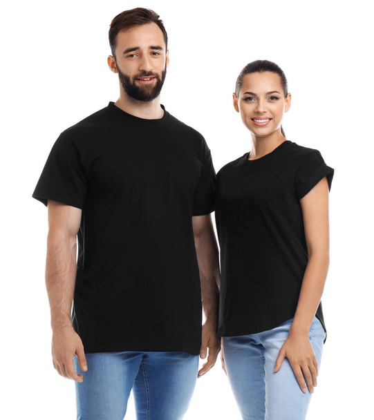 Young couple in t-shirts on white background. Mockup for design - Фото, изображение