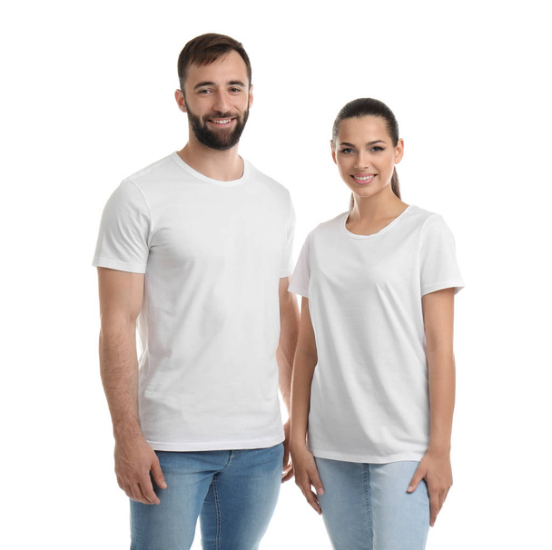 Young couple in t-shirts on white background. Mockup for design - Foto, Imagen
