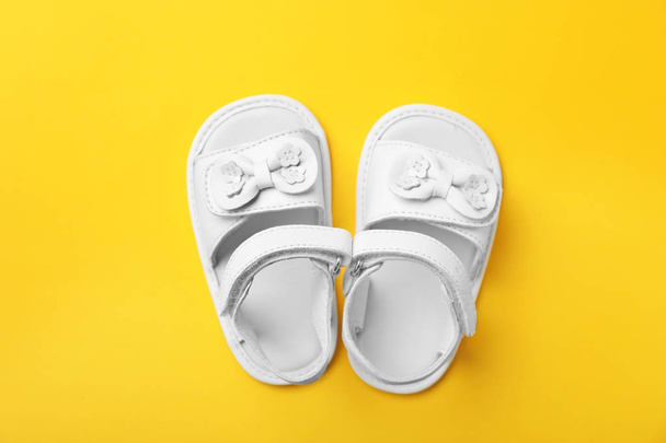 Pair of cute baby sandals on color background, top view - Φωτογραφία, εικόνα