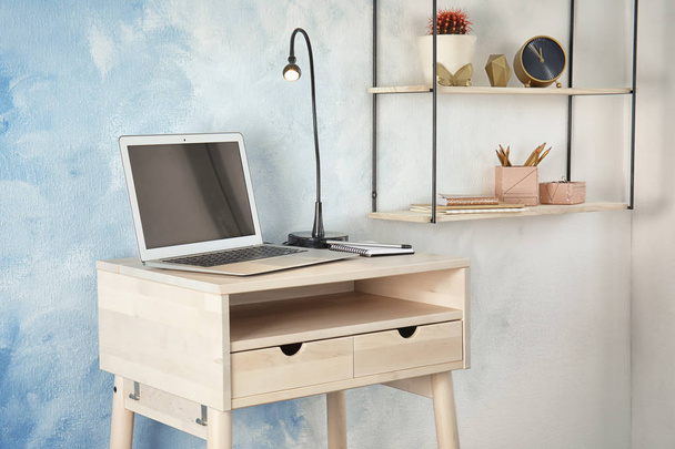 High wooden table with laptop as stand up workplace in modern interior - Foto, Imagen