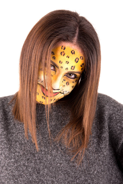 Beautiful young woman with face painted as a leopard - Φωτογραφία, εικόνα