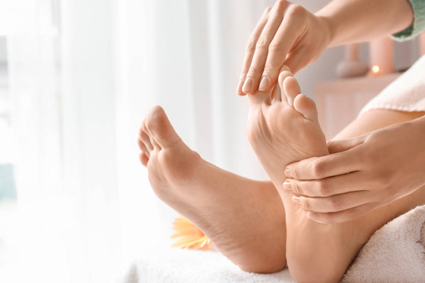 Beautiful young woman receiving foot massage in spa salon - Valokuva, kuva