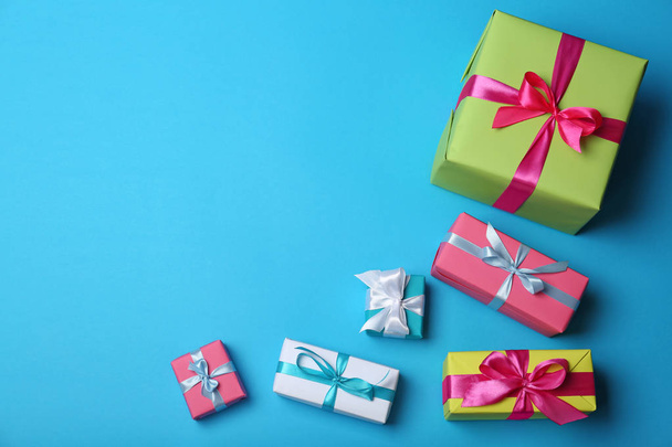 Flat lay composition with gift boxes on color background - Fotó, kép