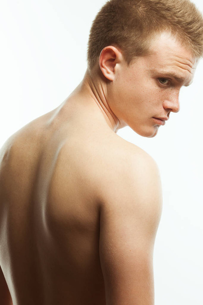 Natural male beauty concept. Close up portrait of handsome charismatic young man's back posing over white background. Studio shot - Fotoğraf, Görsel