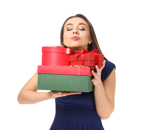 Beautiful young woman with gift boxes on white background - Foto, immagini