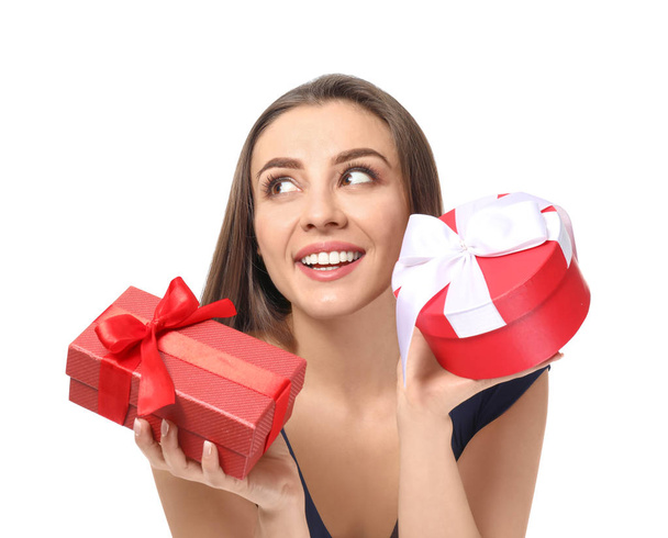 Beautiful young woman with gift boxes on white background - Fotoğraf, Görsel