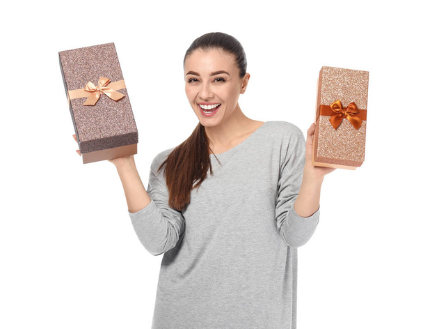 Beautiful young woman with gift boxes on white background - Fotó, kép
