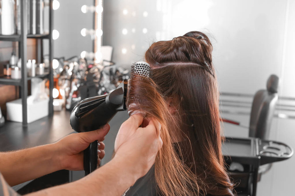 professioneller Friseur arbeitet mit Klient im Schönheitssalon - Foto, Bild