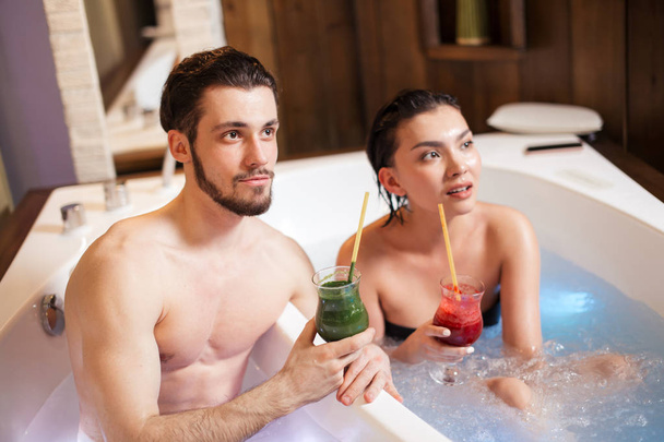 close up shot. woman and man with refreshments in the spa center - Foto, immagini