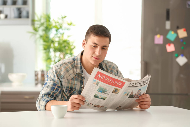 Man reading morning newspaper during breakfast at home - Photo, image