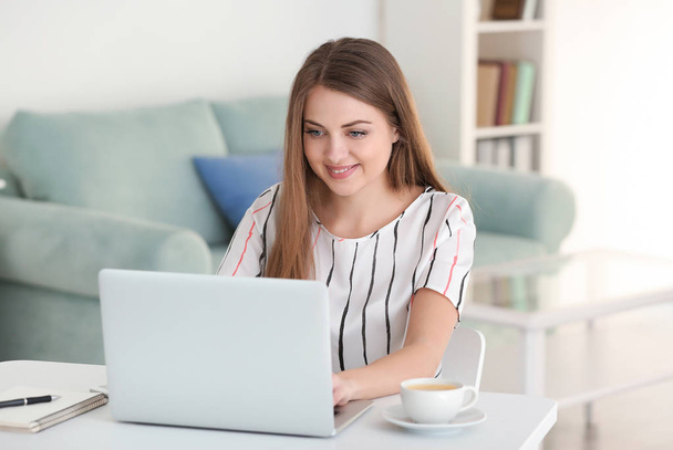 Female freelancer working on laptop in home office - Photo, Image