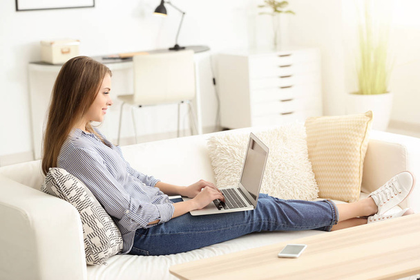 Female freelancer working on laptop at home - 写真・画像