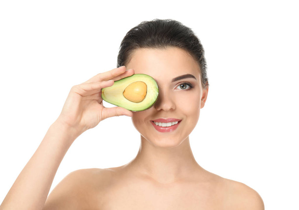 Beautiful young woman with avocado on white background - Fotó, kép