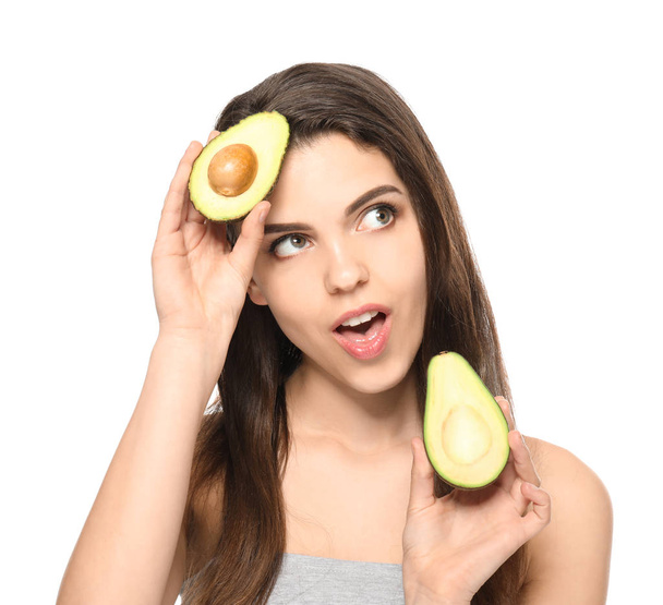 Beautiful young woman with avocado on white background - Photo, Image