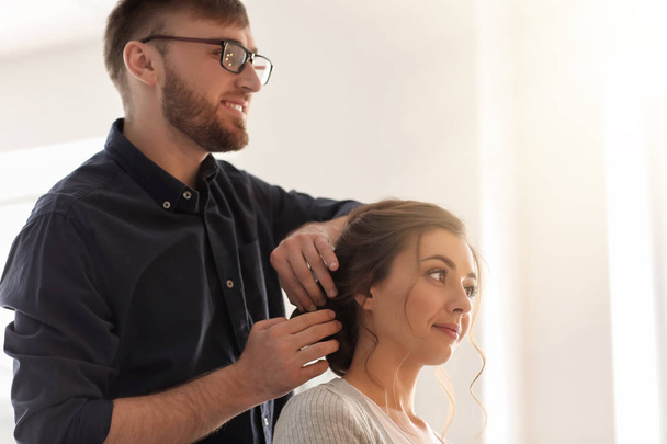 Professional hairdresser working with client in salon - Fotoğraf, Görsel