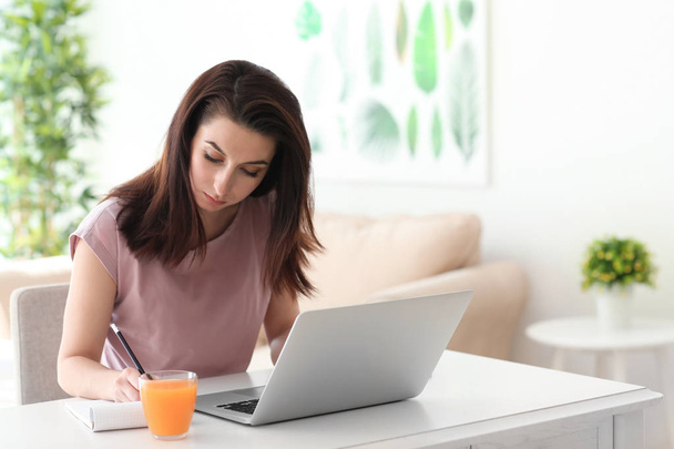 Young female freelancer working at home - Photo, Image