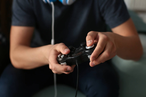 Teenager playing video games at home, closeup - Photo, Image