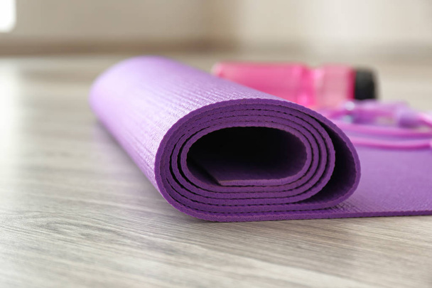 Yoga mat on wooden floor - Foto, Imagen