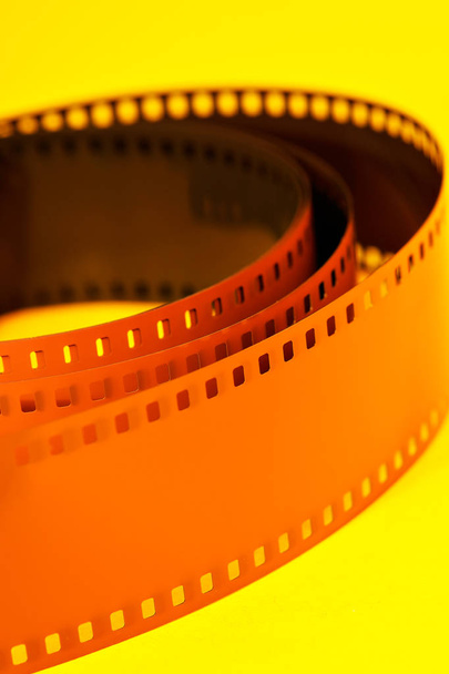 Film negative on yellow - Photo, Image