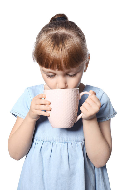 Cute little girl with cup of hot cocoa drink on white background - Foto, Imagen